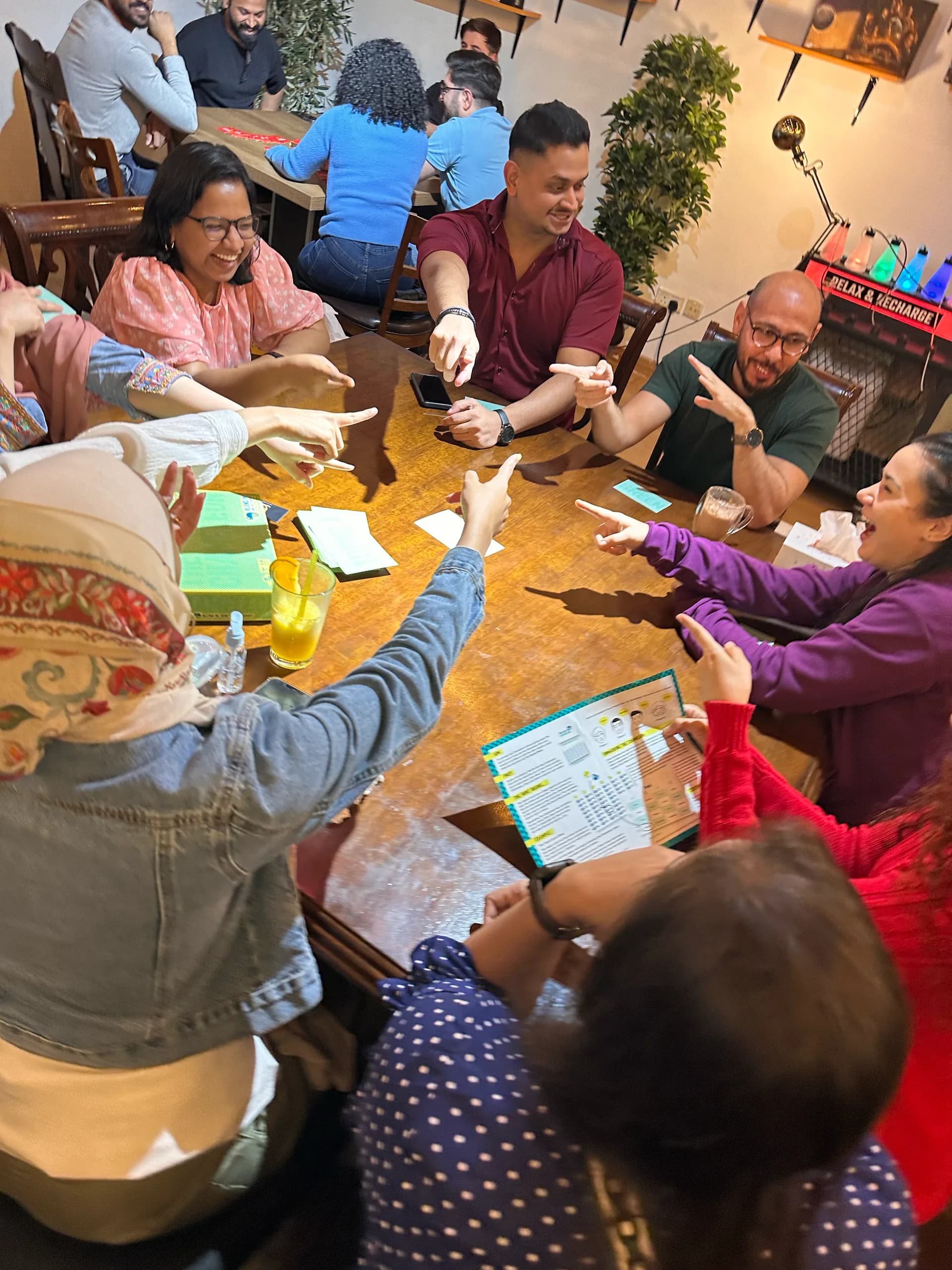 A full table mid game, everybody pointing at once as the vote goes round