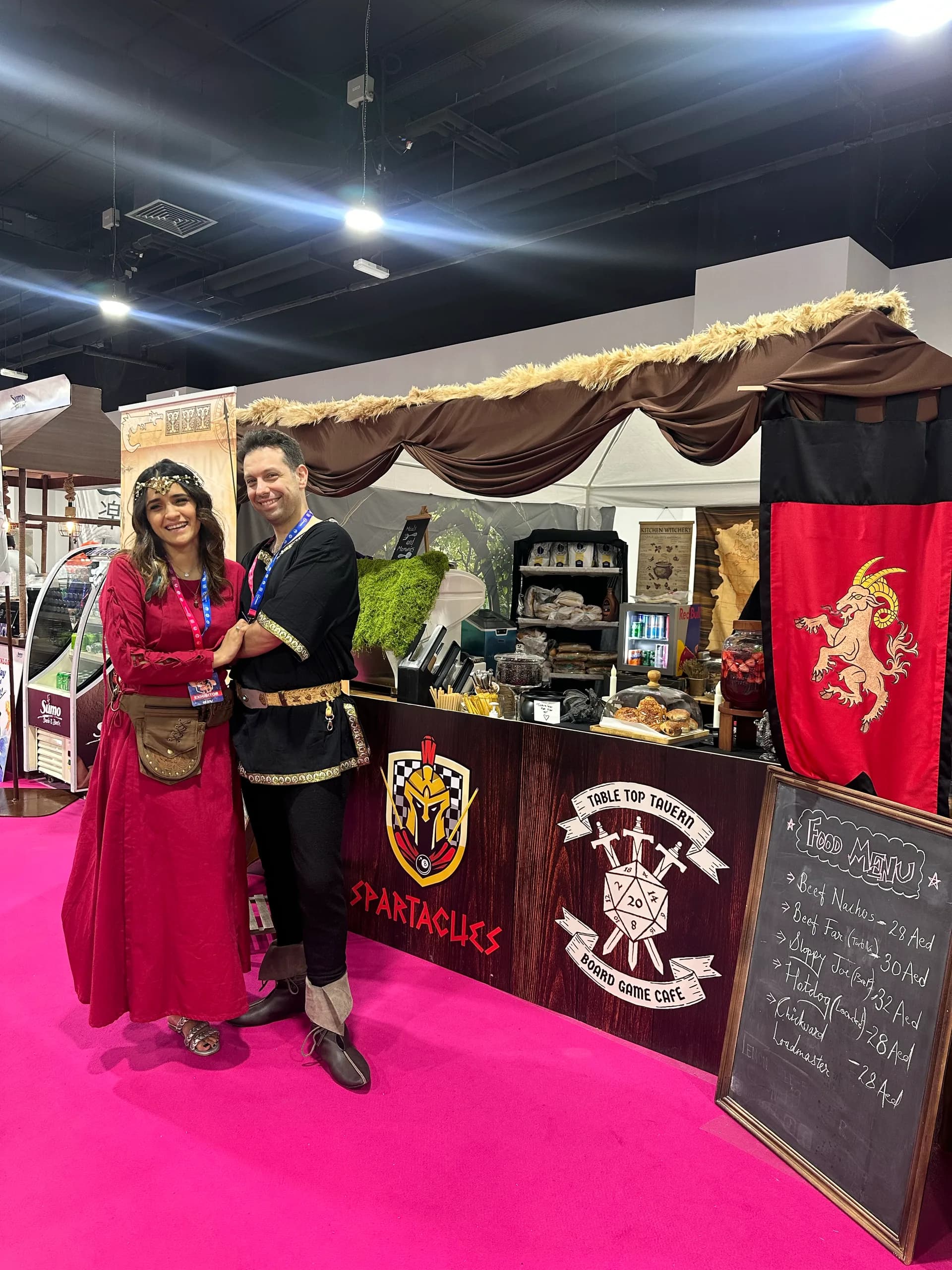 Hiba and Georgios in medieval costume on the Spartacues stand at an expo